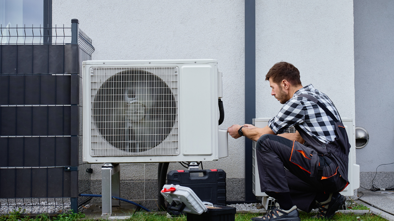 Technician completing final HVAC system check